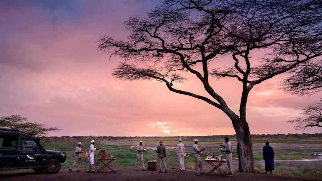 Tanzania-Serengeti-Under-Canvas-SUC-Experience-guest-delight-Bush-safari-Drinks-sundowners-at-sunset-5-Collections-3000w-1-scaled